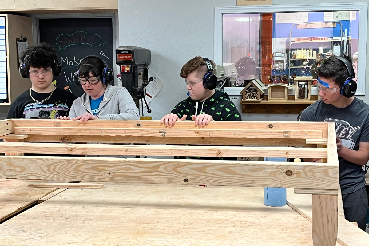 Four students work on building a bed frame at a Talent Maker City workshop