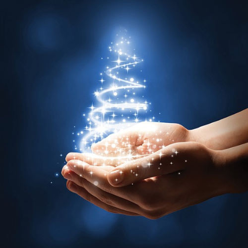 A holiday tree made of light is held in someone's palms, illuminated against the dark blue background