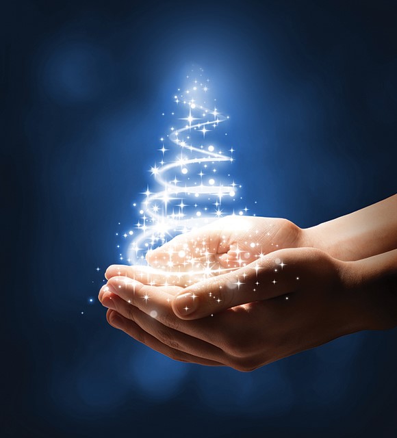 A holiday tree made of a swirl of light is held in someone's cupped hands